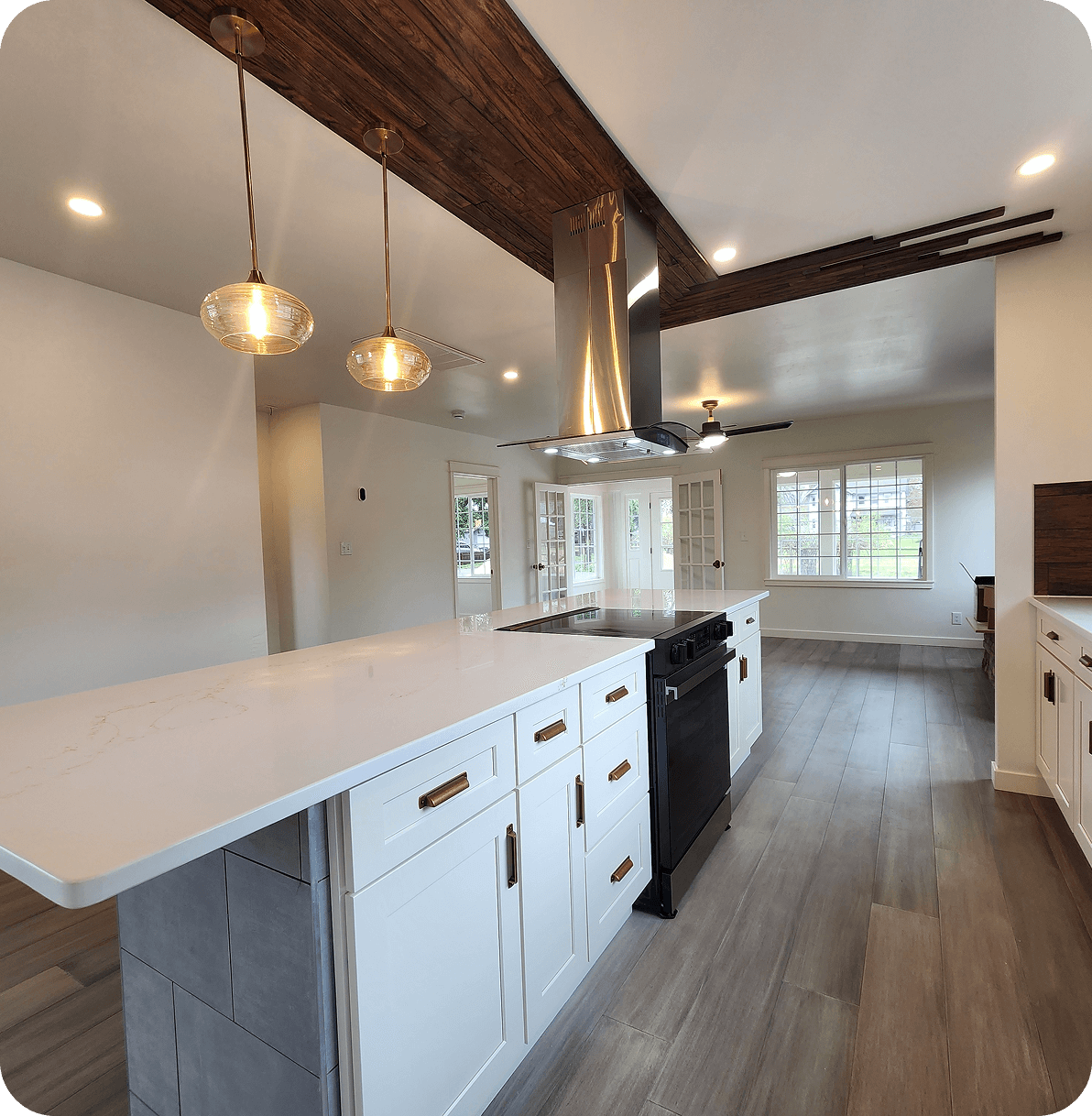 Modern kitchen with island and pendant lights.