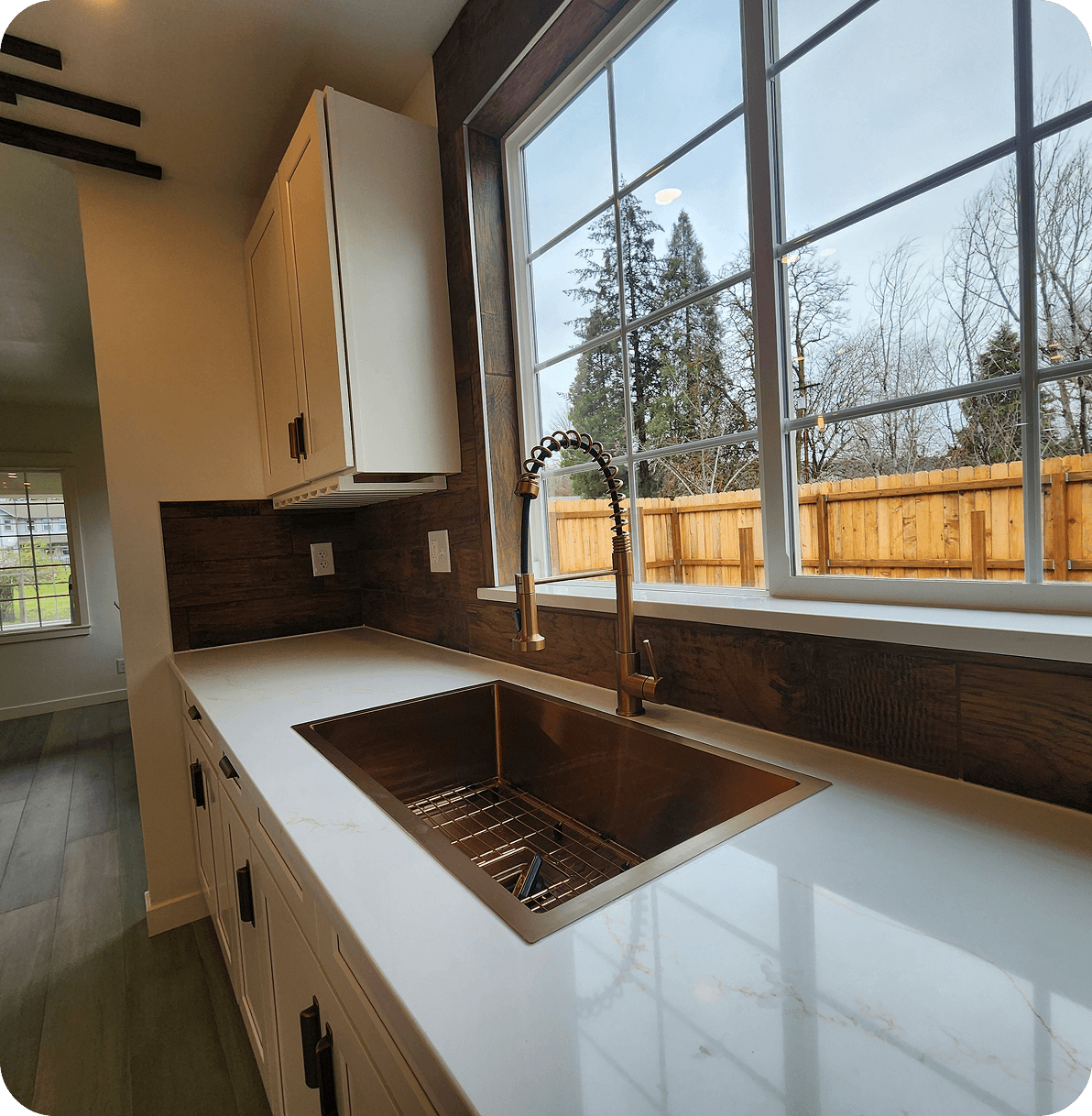 Modern kitchen with large window and sink.