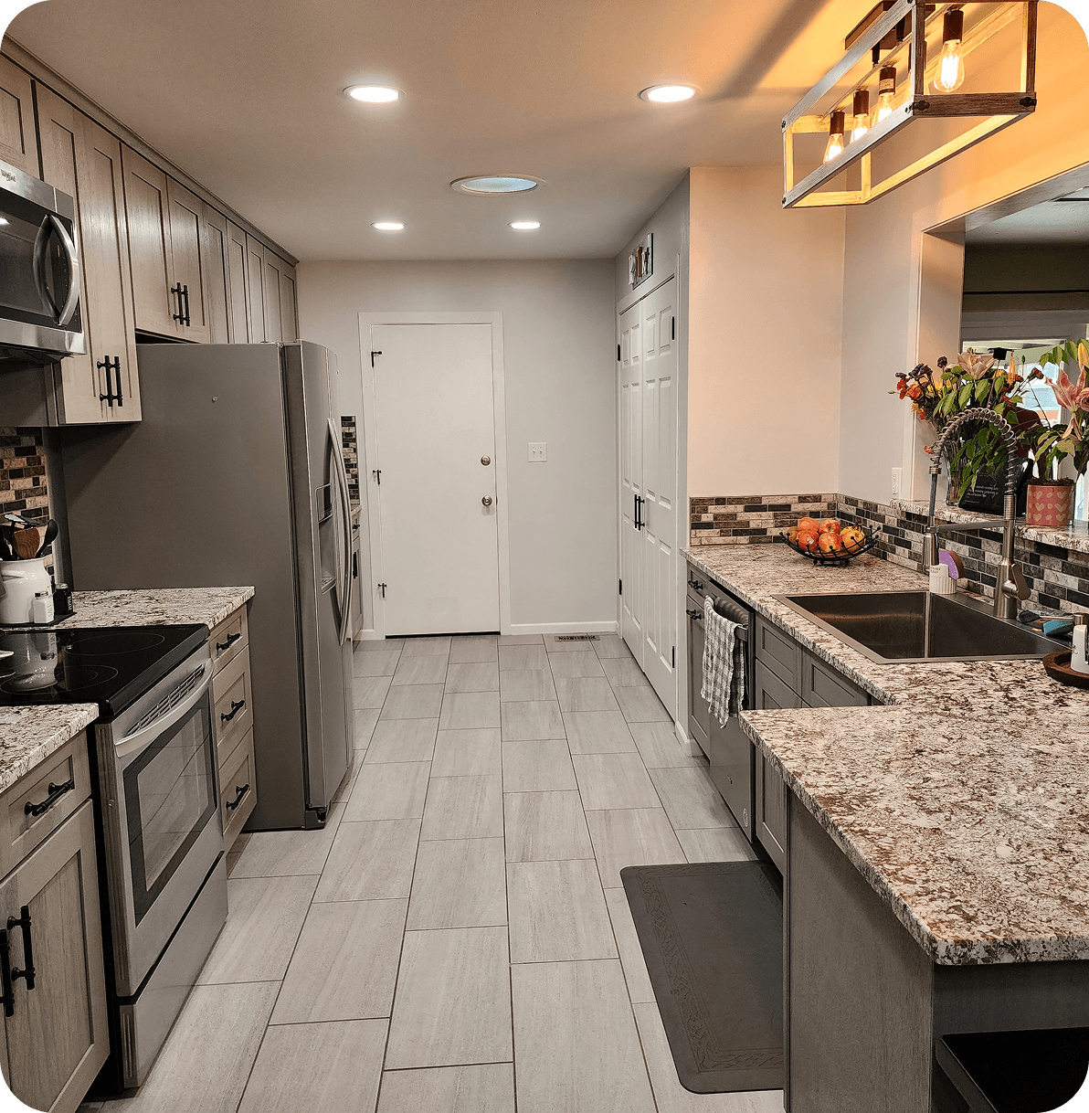 Modern kitchen with granite countertops and appliances.