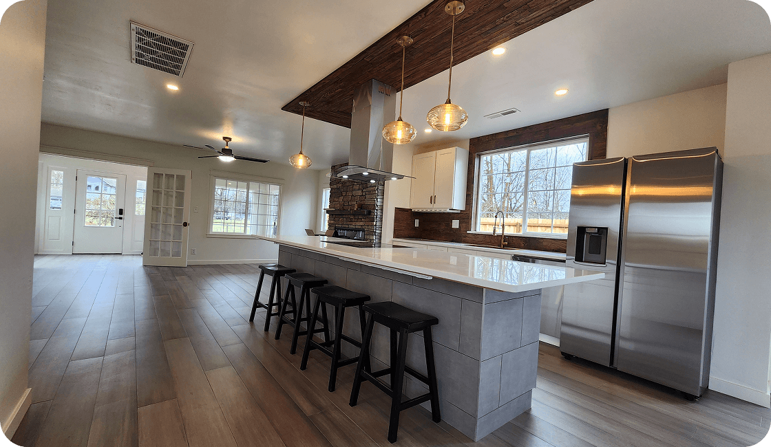 Modern kitchen with island and stainless appliances.
