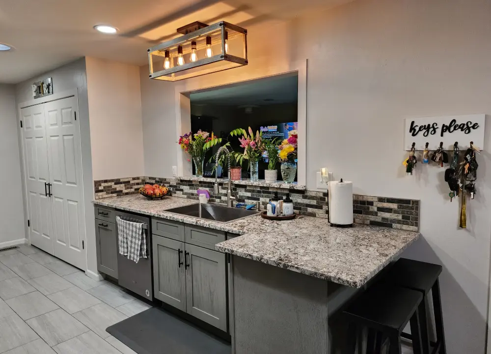Modern kitchen with flowers and key hooks.